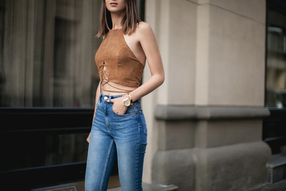 Woman wearing a halter top outfit with a midi skirt and heels for an evening event