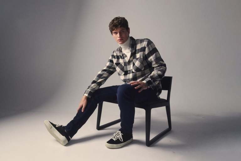 Man wearing jeans outfit ideas for men with hoodie and boots