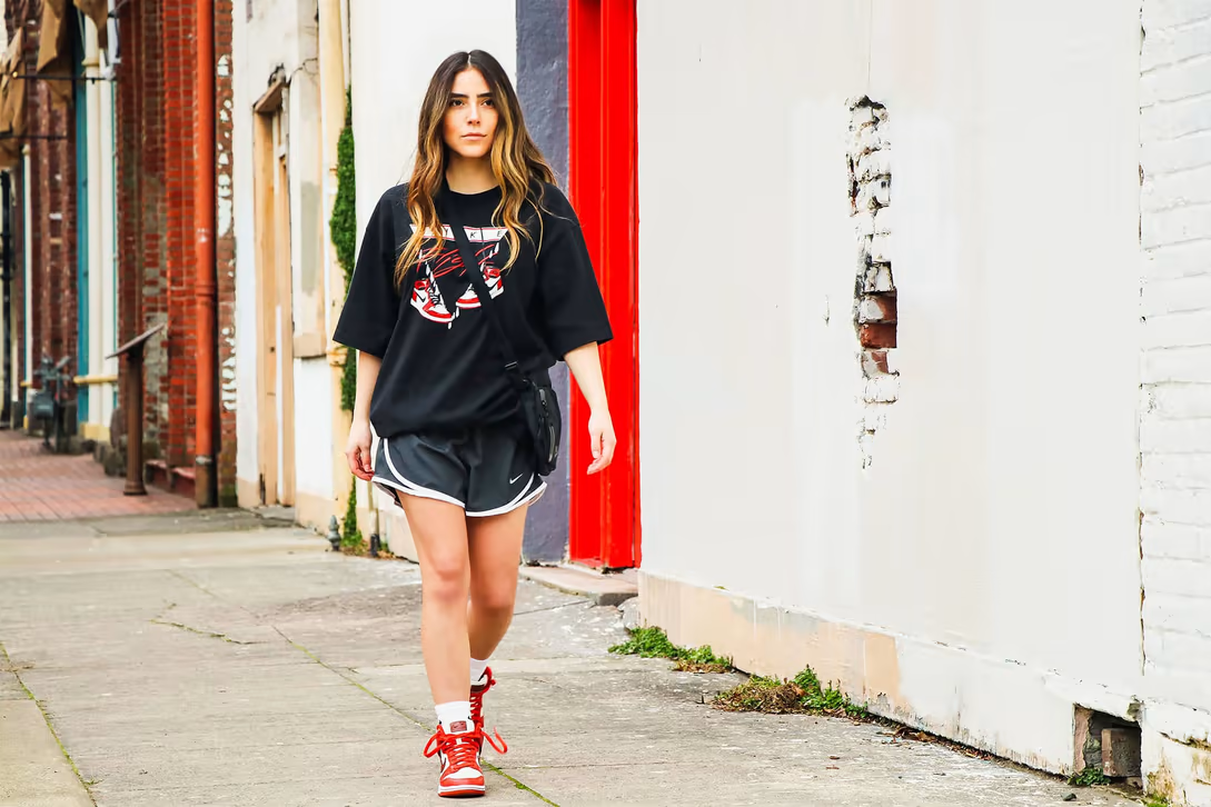 Oversized tee outfits styled with tapered jeans and a cap